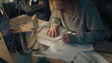 Woman sketching comic book panels at a desk