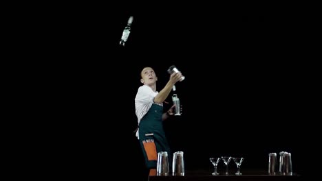 Isolated-Bartender-juggling-the-objects-on-black-background