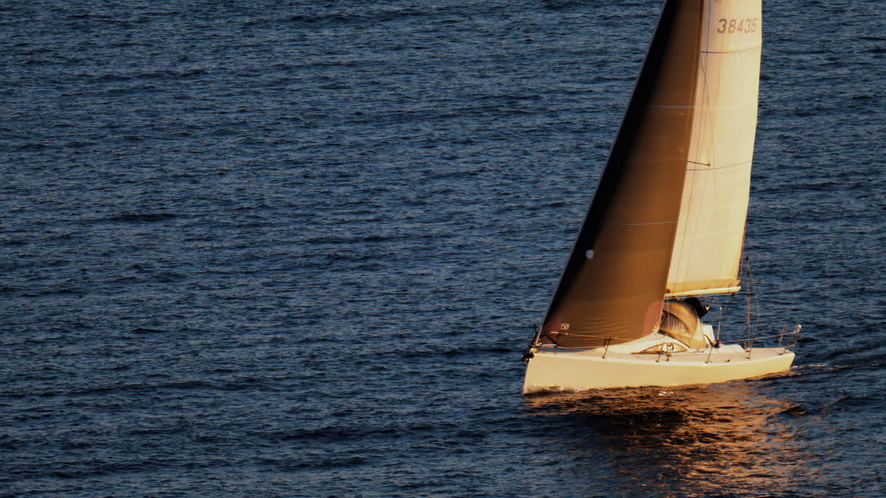 Cannes, France - March 13, 2025: Sail boat moving alone on the sea on a sunny day