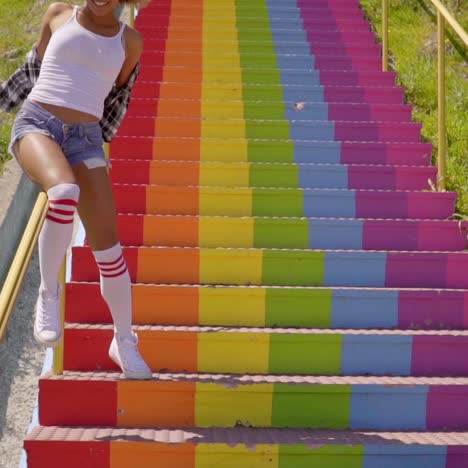 woman sliding down metallic banisters