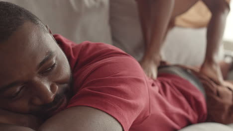 child legs stepping on tired man lying