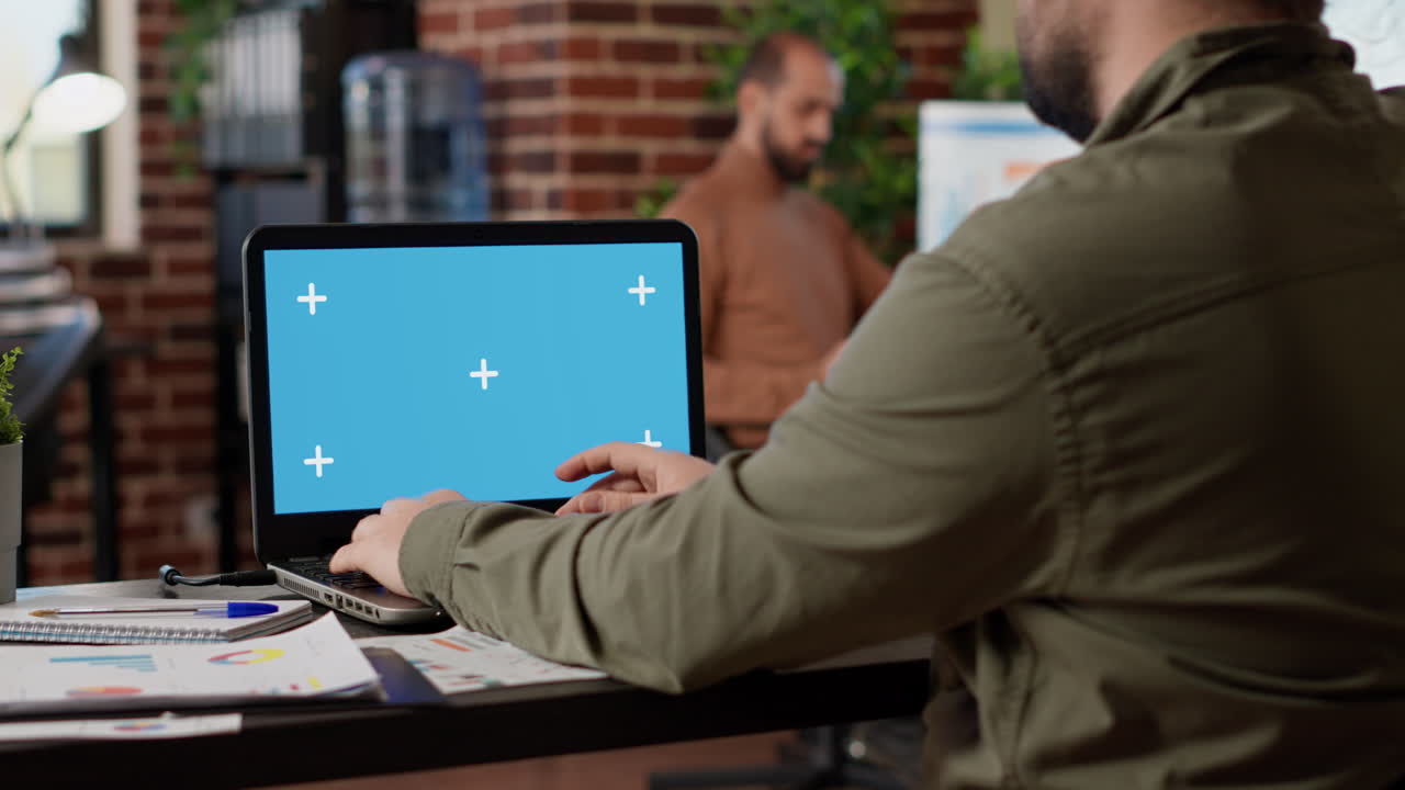 Businessman working on freelance with greenscreen on laptop