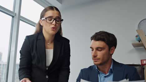 Stressed-colleagues-checking-documents-closeup.-Mad-businessman-throwing-papers