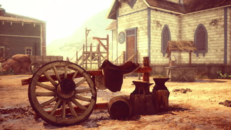 rustic cart and anvil in an old western town during golden hour