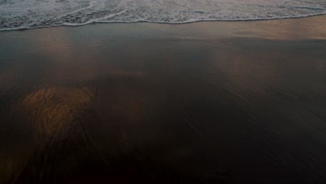 rolling waves of el paredon beach in guatemala at sunset - handheld