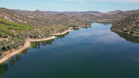 picturesque aerial view of sierra de andujar nature reserve and encinarejo reservoir blue waters