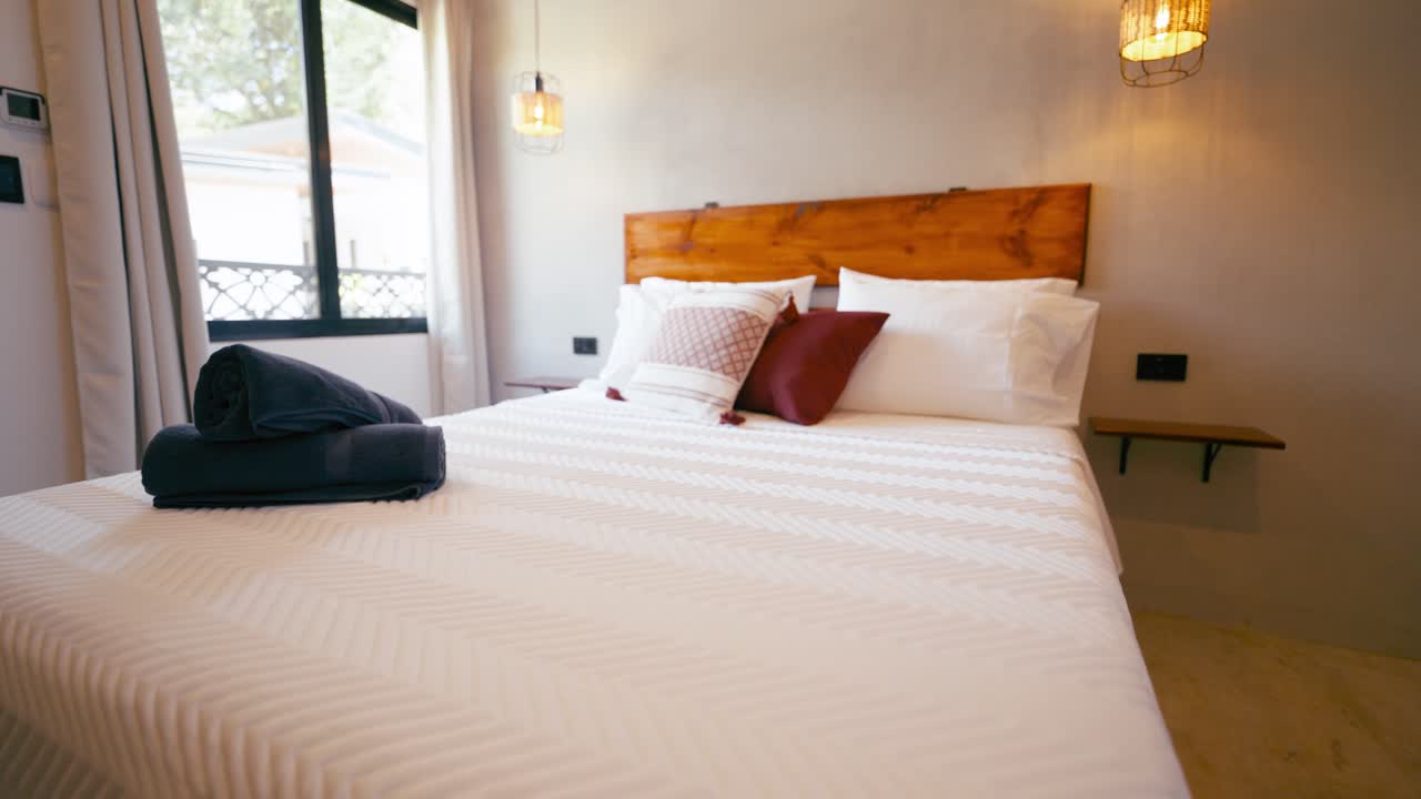 Modern and Clean Bedroom Interior with White Bed and Wooden Headboard