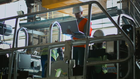 factory workers inspecting machinery