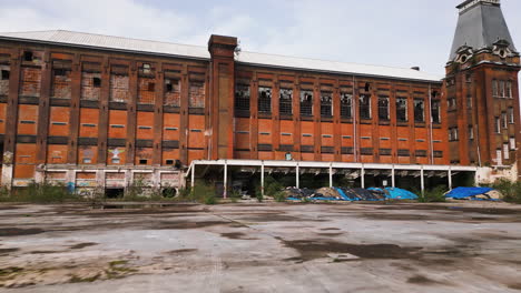 Abandoned-industrial-building-in-Belgium,-aerial-fly-forward-view