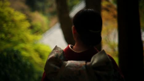 woman in kimono at a japanese temple in autumn