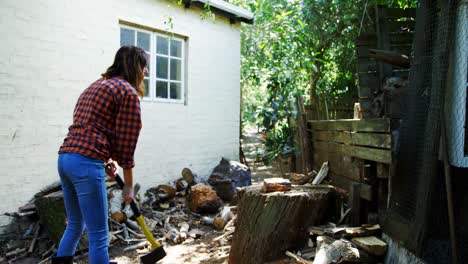 Woman-chopping-wood-with-axe-4k