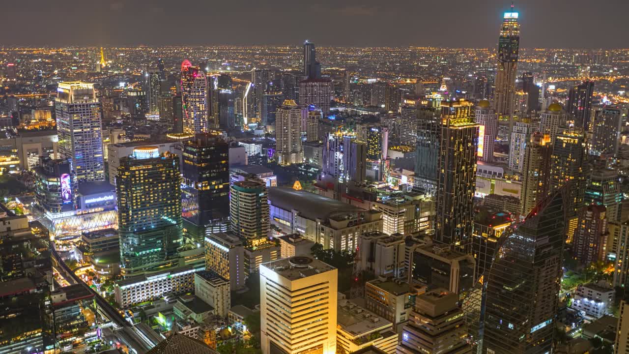 Aerial view of Ploenchit junction with cars traffic skyscraper buildings. Bangkok City in downtown at night, Thailand