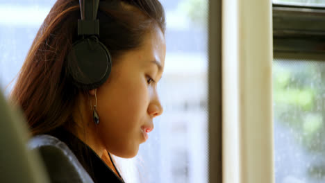 teenager girl listening to music on headphones 4k