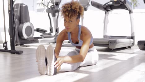 girl practicing yoga in gym