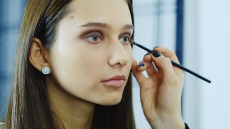 makeup artist young woman's make up in a studio 4