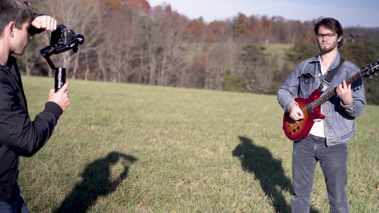 Musician Filming a Music Video in a Field