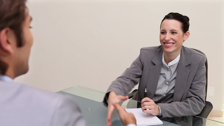 A woman interviewing a man