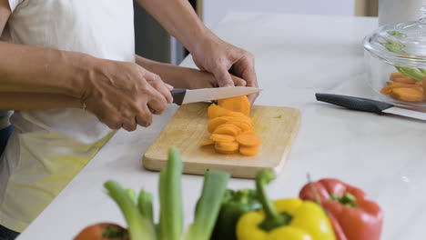 father and daughter cutting carrot.