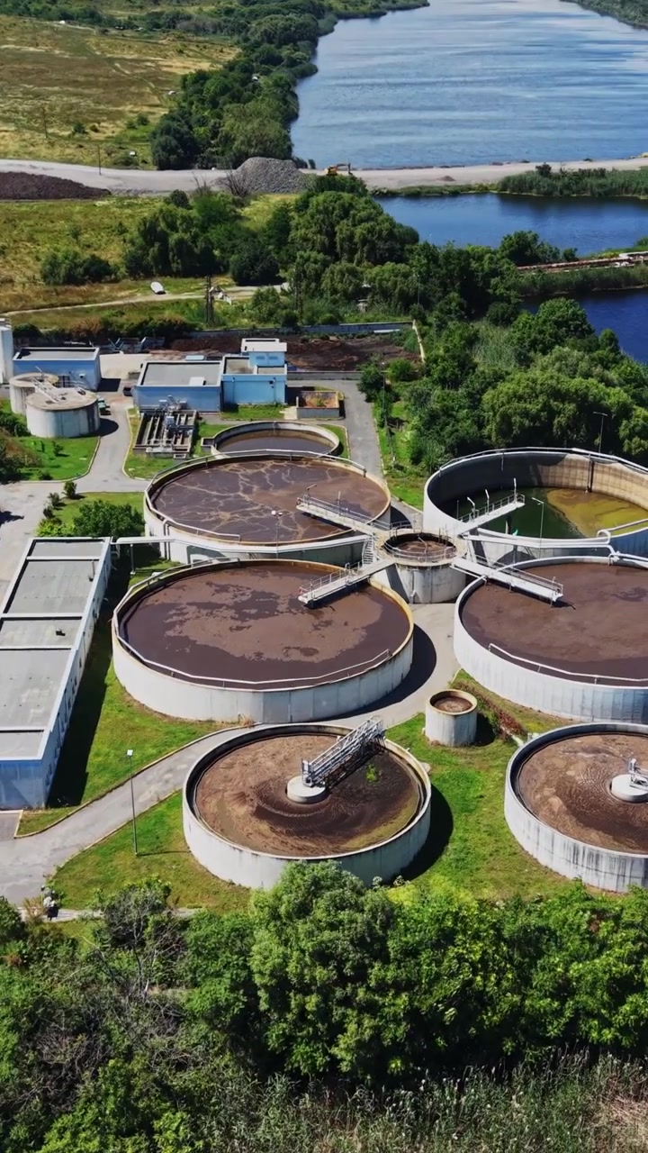 Water treatment facility located near a river with green fields and roads