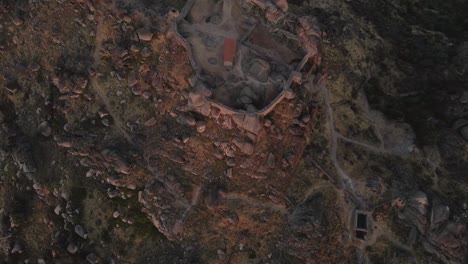 monsanto castle ruins at sunrise, portugal.aerial top-down forward