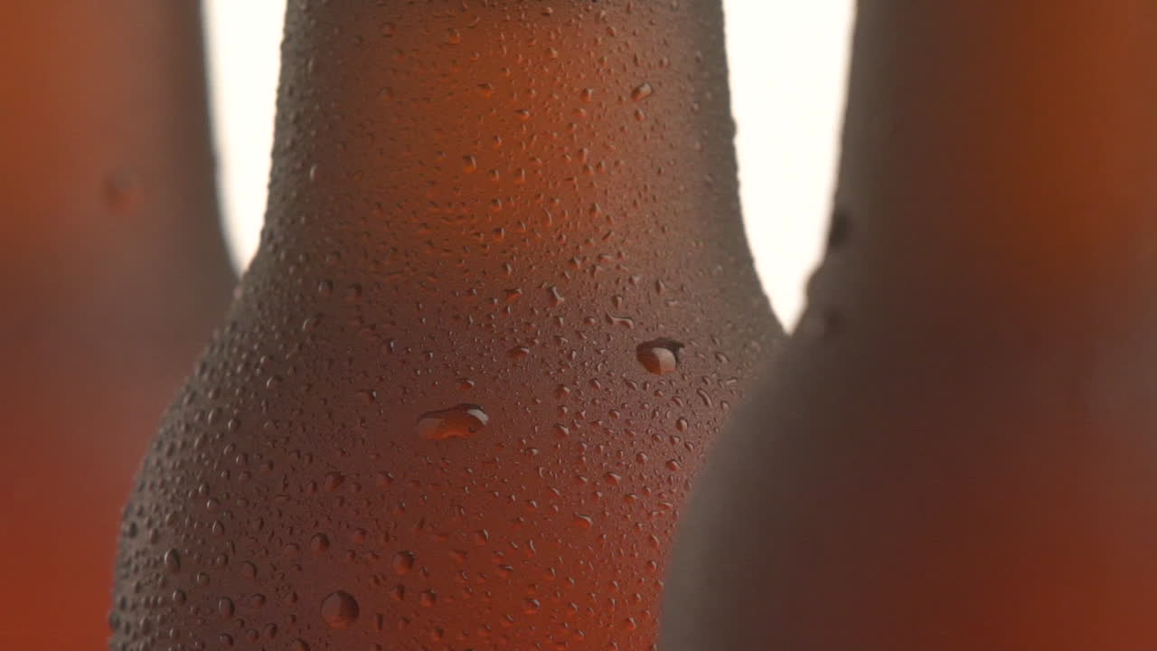 Three beer bottle rotating on white background