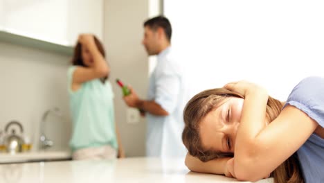 Upset-girl-covering-her-ears-while-her-parents-fight