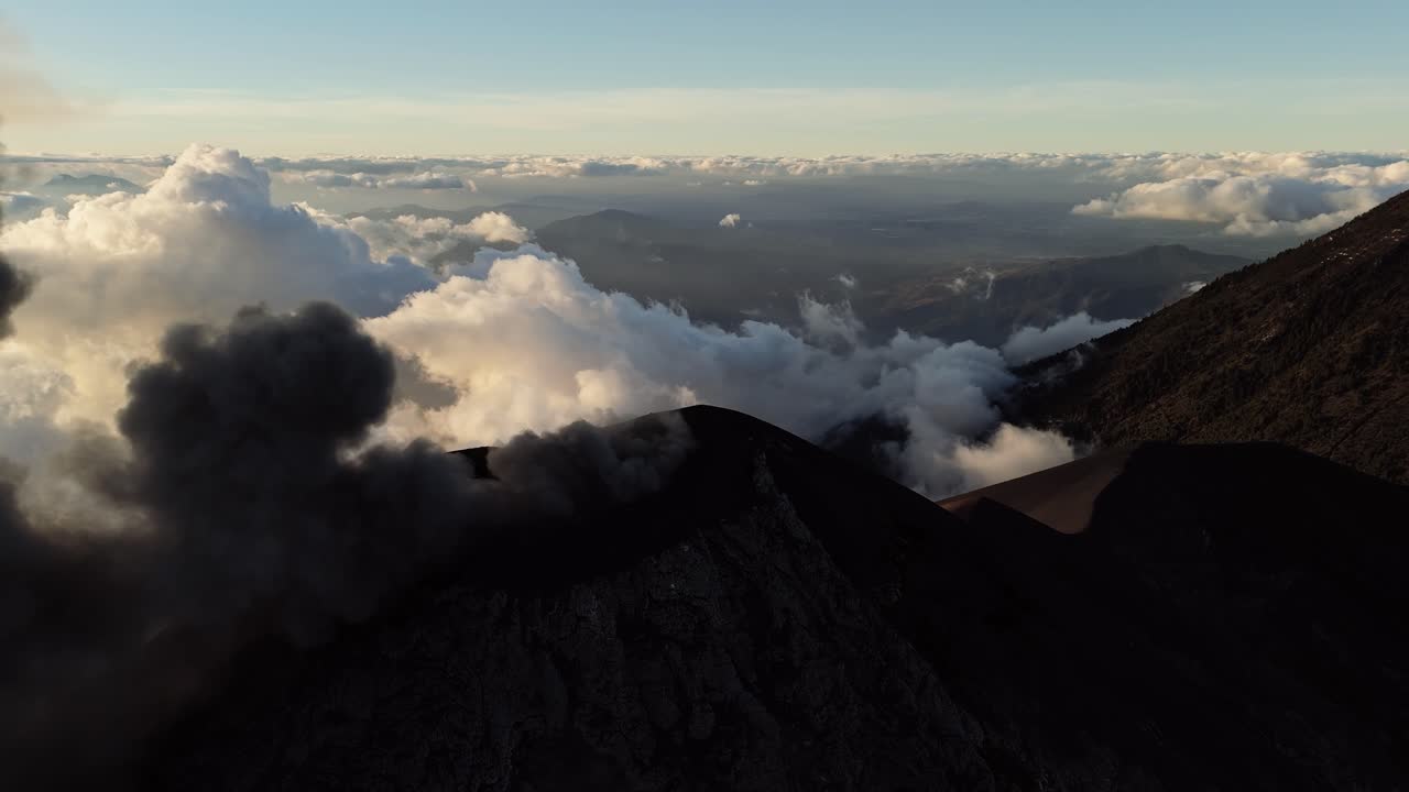 Black smokes and ashes rises from volcano, aerial drone view