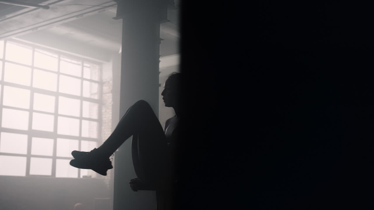 Woman pumping abdominal muscles in sport club. Sporty girl doing abs exercises