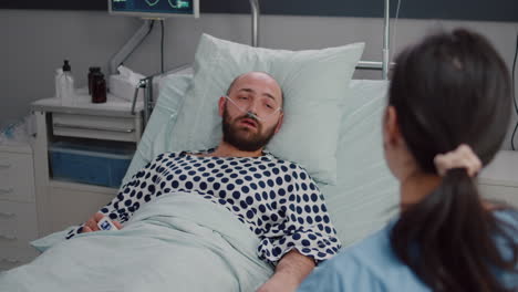 medical nurse explaining bones x-ray to hospitalized sick man during disease recovery