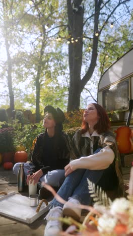 two women relaxing outdoors in autumn