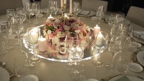 decorated wedding table with flowers candles and glassware in warm evening light
