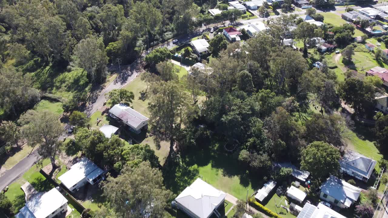 4K aerial drone shot of private homes some with swimming pools in Ipswich a small town in Australia