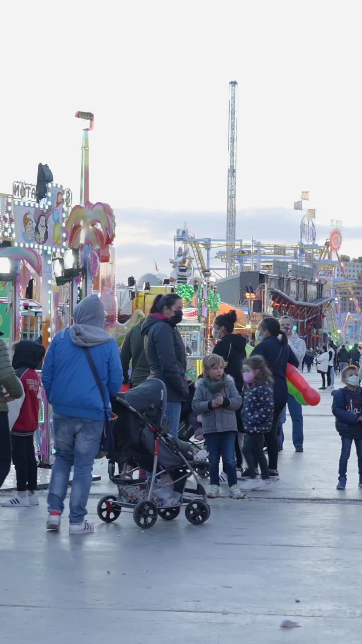 People enjoying a lively amusement park or fairground