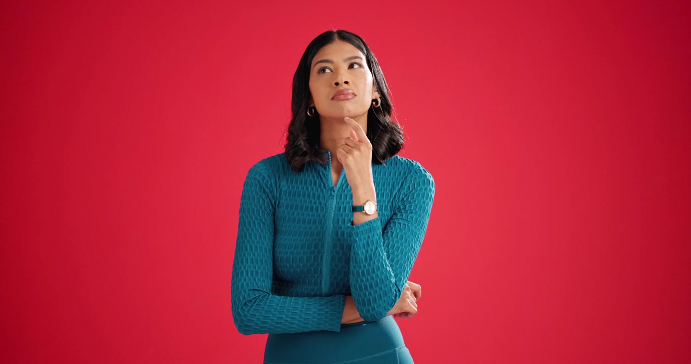 Thoughtful Young Woman Pondering Against Red Background