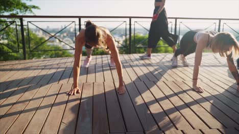 women doing plank exercise outdoors