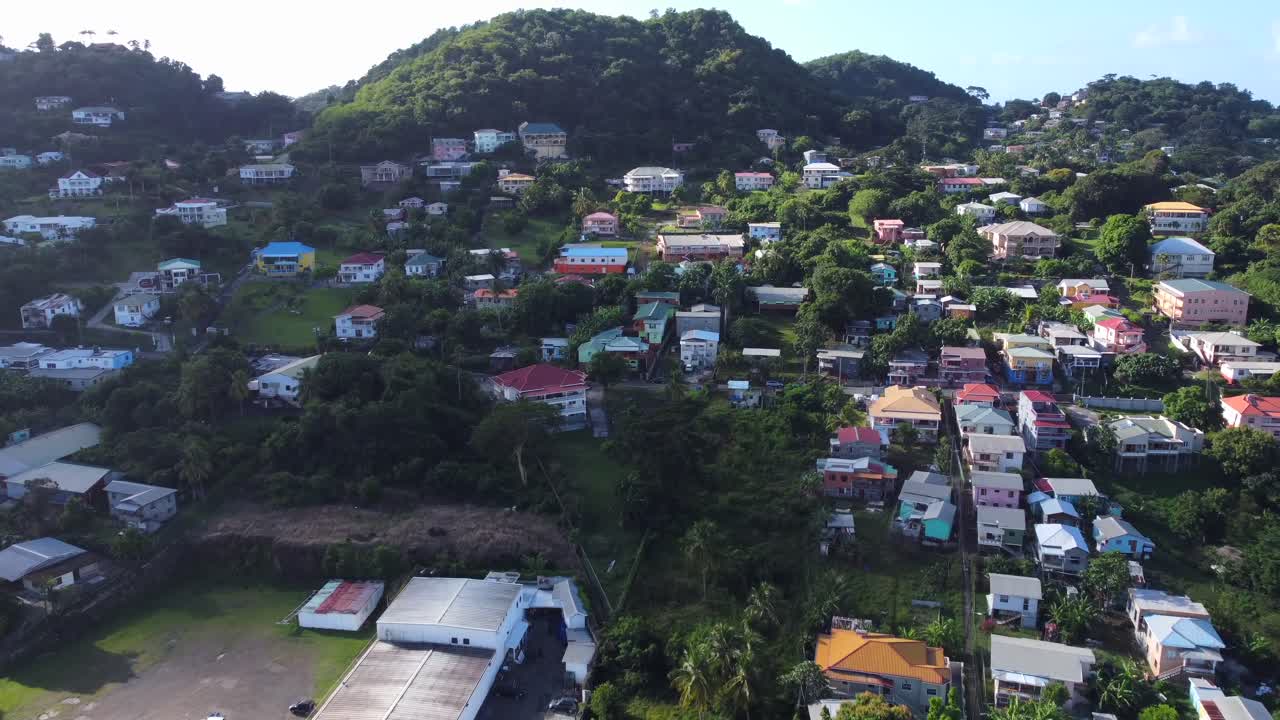 Establishing real estate drone shot of hillside houses in a small town