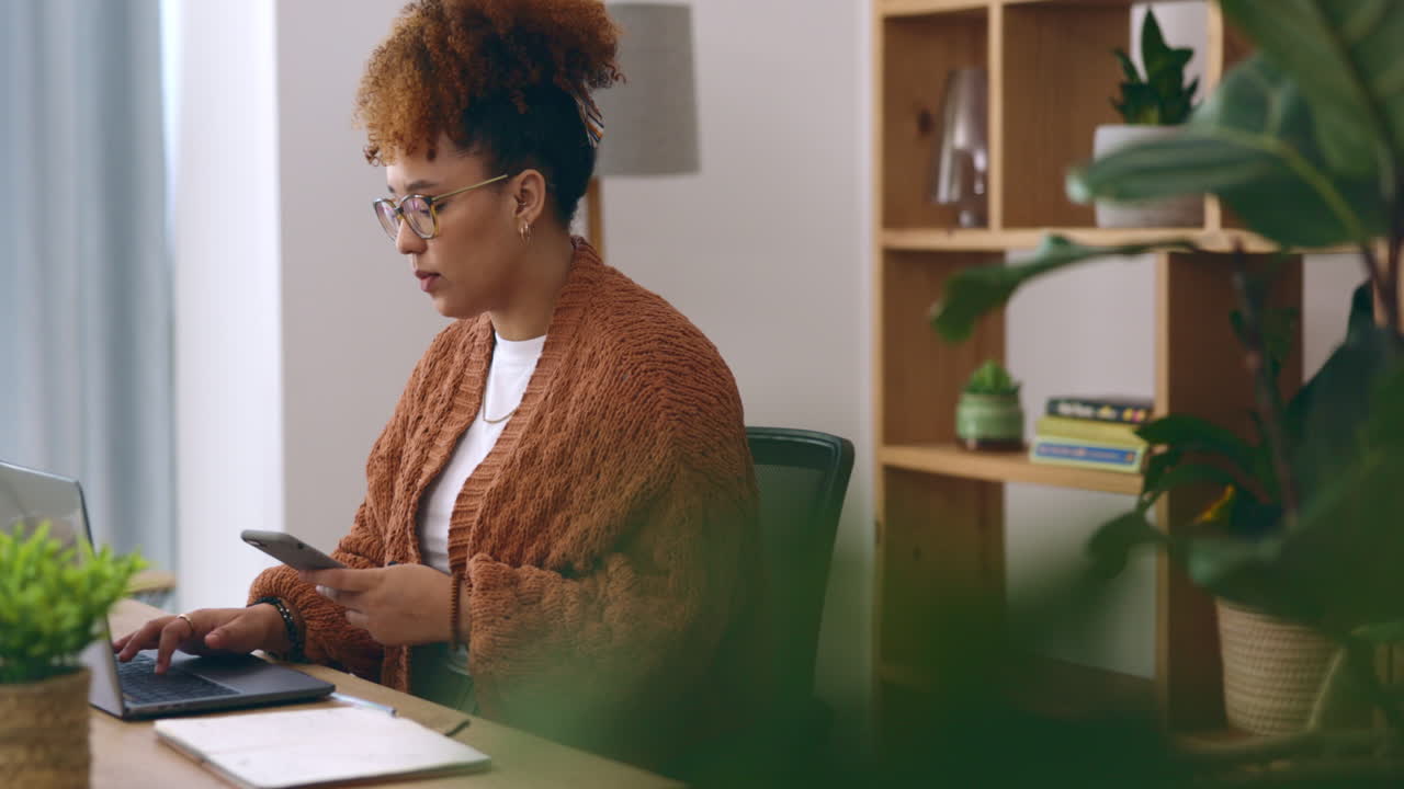 Remote work, typing with phone and laptop