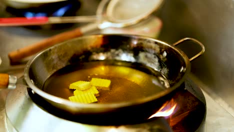 potatoes frying in hot oil on stove