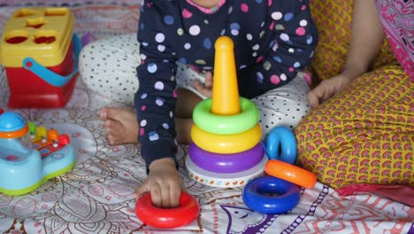 child playing with a baby toys on bed, child development concept.