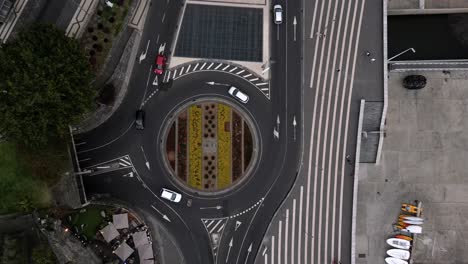 cars turning over francisco sá carneiro roundabout in funchal, portugal