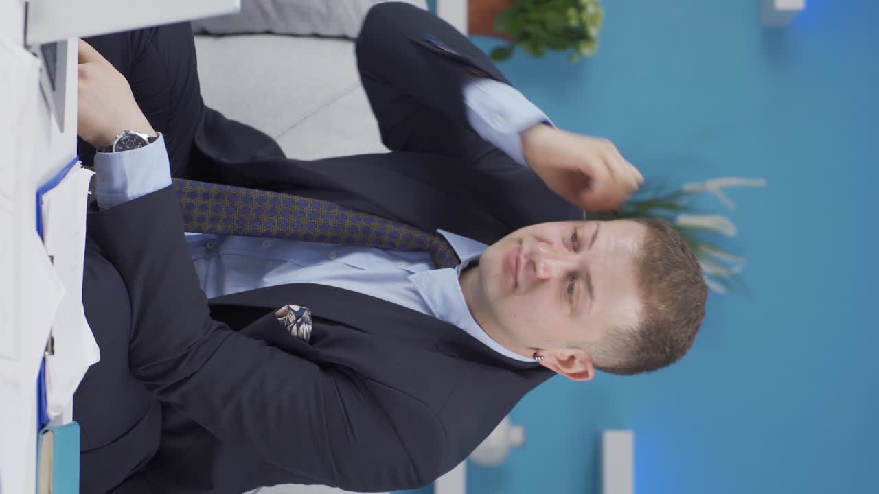 홈 오피스 직원 남자가 문서를 검사하고 분석하는 수직 비디오.