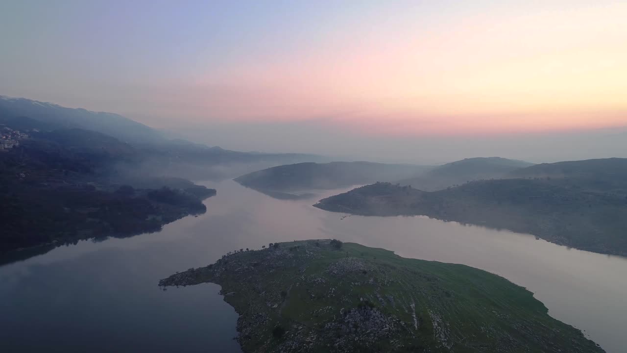Cinematic aerial view of lake at sunrise- 4k- aerial shot on sunse, 4k drone footage with clouds and fog at morning