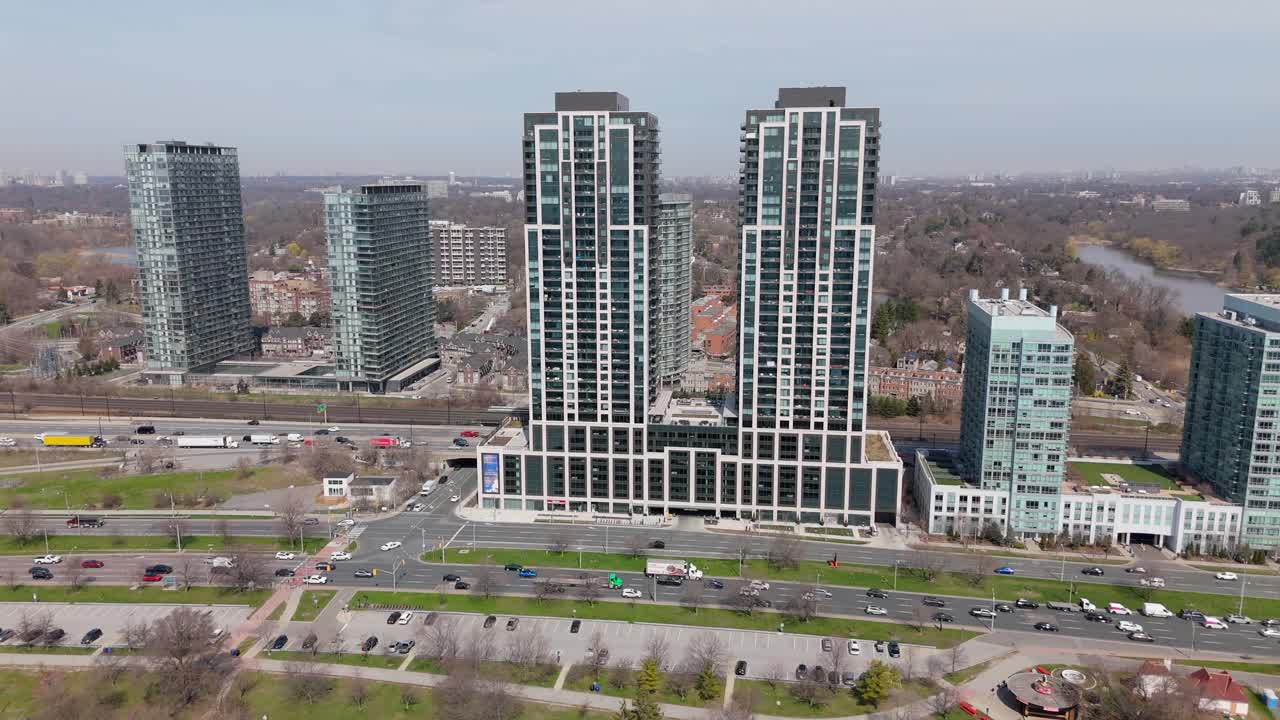 Aerial approaching shot of traffic scene on expressway in Toronto Suburb, Canada. Mirabella Condominiums Buildings at Lakeshore Boulevard And Gardner Expressway.Luxury residential blocks with bay view