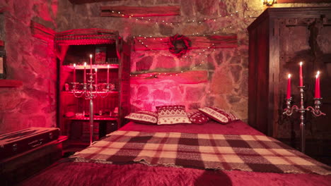 old-fashioned style bedroom in private manor outside the city. festively decorated cozy room in castle-like manner lit in red light.