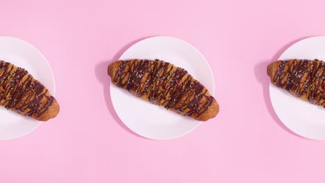 three fresh delicious croissants move on pink theme. stop motion