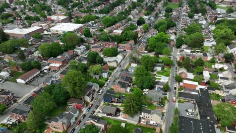 green tree-lined roads of american housing area. aerial top down shot. parking cars along straight street in lancaster. spring day in may. sunny day in suburbia. wide shot. pa, united states.