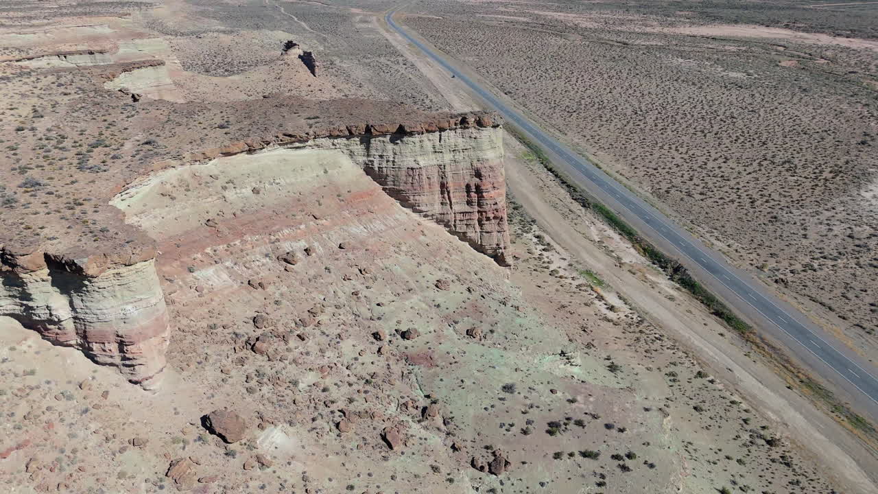 Rugged Patagonian terrain with colorful cliffs and Route 45 stretching along it