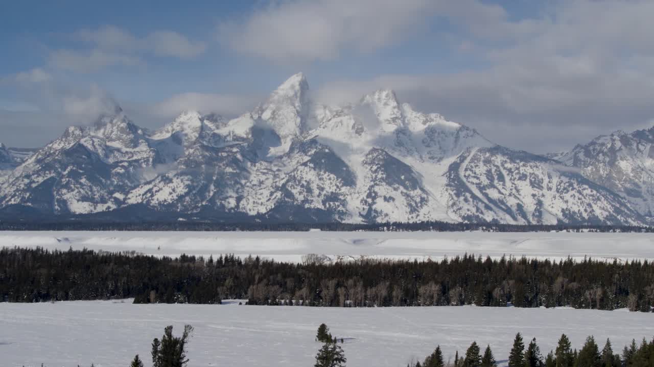 A 4K drone shot of The Grand Teton, the largest and tallest mountain top of the Teton range, in Grand Teton National Park in Northwestern Wyoming