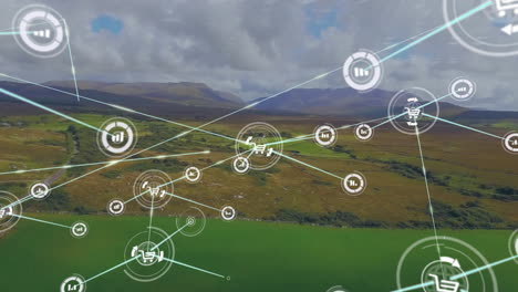 animación de iconos conectados sobre vista aérea de paisajes verdes y montañas contra un cielo nublado