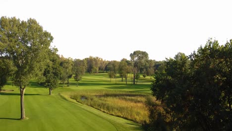 establishing rising aerial view of empty golf course during sunny weather day